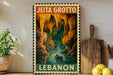 A framed poster of a cave scene with a person in a boat, depicting Jeita Grotto, a famous underwater cave system in Lebanon.