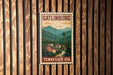 A vintage-style metal sign with the text "GATLINBURG TENNESSEE USA" displayed on a wooden wall.