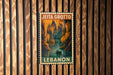 A poster of Jeita Grotto, a famous cave system in Lebanon, is displayed on a wooden wall.