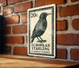 A 20 cent European starling postage stamp is displayed on a brick wall.