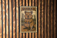 A poster of a quokka, a small marsupial, is displayed on a wooden wall.