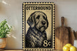 a large metal stamp with a dog's portrait on it, placed on a wooden surface next to a wooden cutting board and some lemons.