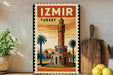 A vintage-style metal sign with the text "IZmir Turkey" and an illustration of a tower, palm trees, and a desert landscape.