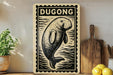 a wooden sign with a black and white illustration of a dugout, placed on a wooden surface next to a wooden cutting board and a potted plant.