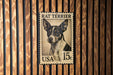 A metal stamp featuring a portrait of a Rat Terrier dog, with the text "RAT TERRIER" and "USA 15¢" printed on it.