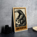 a metal sign with an illustration of an ant eater, placed on a table next to some black camera lenses.