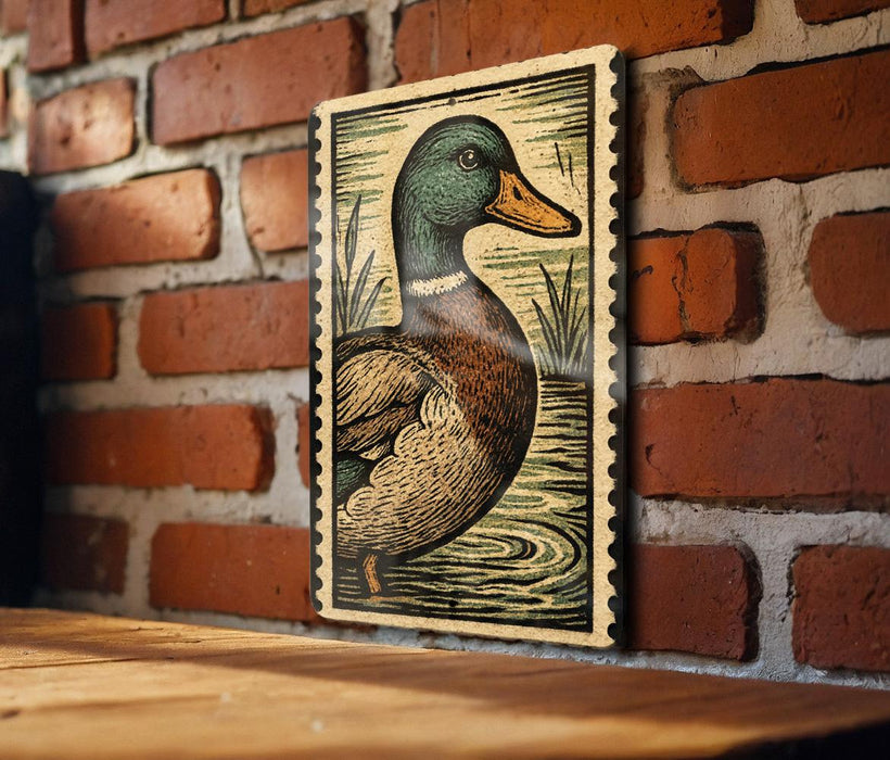A framed illustration of a duck is hanging on a brick wall.