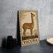 a metal sign with a stamp-like border, depicting a llama, and the word "VICUNA" written below it.