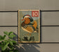 A vintage postage stamp featuring a colorful bird, likely a mandarin duck, is displayed on a wall.