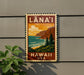 A vintage-style sign with the text "LANA'I" and "HAWAII U.S.A." displayed on a wall, depicting a scenic landscape with mountains, trees, and the ocean.