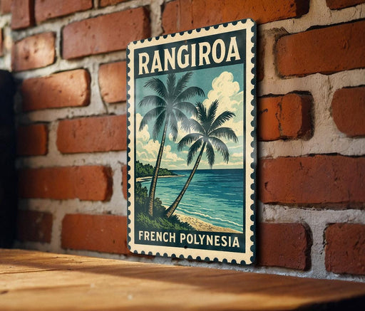 A vintage-style poster of a tropical beach scene with palm trees and the ocean, mounted on a brick wall.