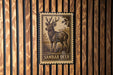 A metal stamp featuring a detailed illustration of a Sambar deer, which is a type of deer native to the forests of India.