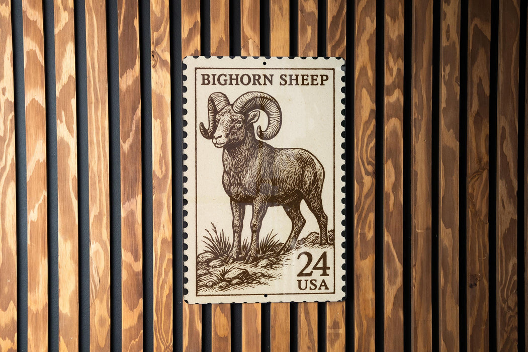 A postage stamp featuring a bighorn sheep, with the text "BIGHORN SHEEP" and "24 USA" printed on it.