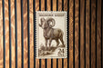 A postage stamp featuring a bighorn sheep, with the text "BIGHORN SHEEP" and "24 USA" printed on it.
