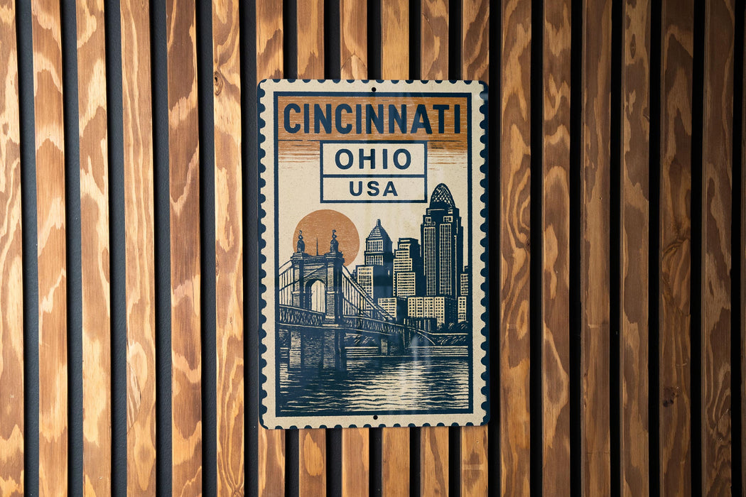 A poster of the Cincinnati skyline, featuring the Cincinnati Bridge, is displayed on a wooden wall.