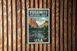 A vintage postage stamp featuring a scenic landscape of Yosemite National Park in the United States.