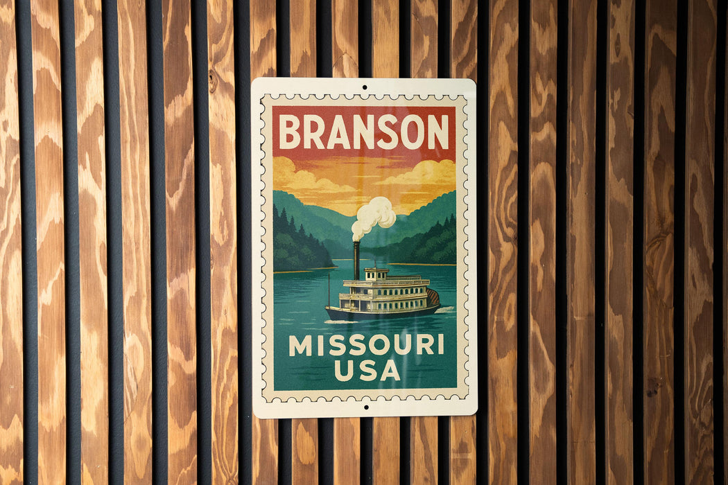 A vintage-style metal sign with the text "BRANSON MISSOURI USA" displayed on a wooden background.