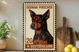A German Pinscher dog is depicted on a metal sign with the text "German Pinscher" and "Deutschland" printed on it, placed on a wooden surface next to a potted plant and a wooden cutting board.