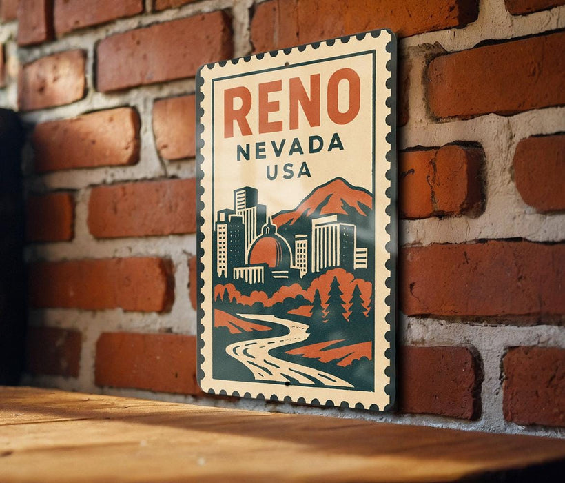 A vintage-style metal sign with the text "Reno, Nevada, USA" displayed on a brick wall.