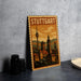 A vintage postage stamp depicting the city of Stuttgart, Germany, with a tower and buildings in the background.