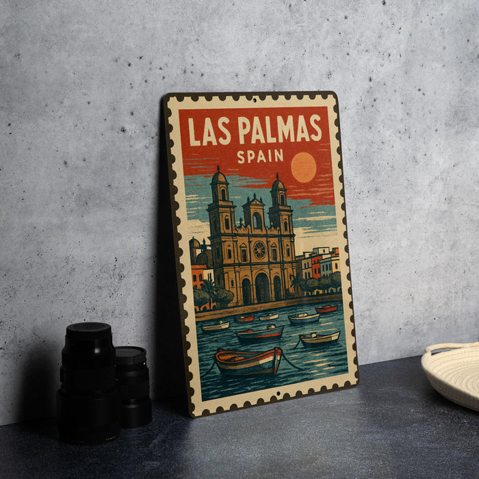 A vintage-style metal sign with a colorful illustration of a cityscape and boats, featuring the text "LAS PALMAS SPAN" (Los Palmas, Spain).