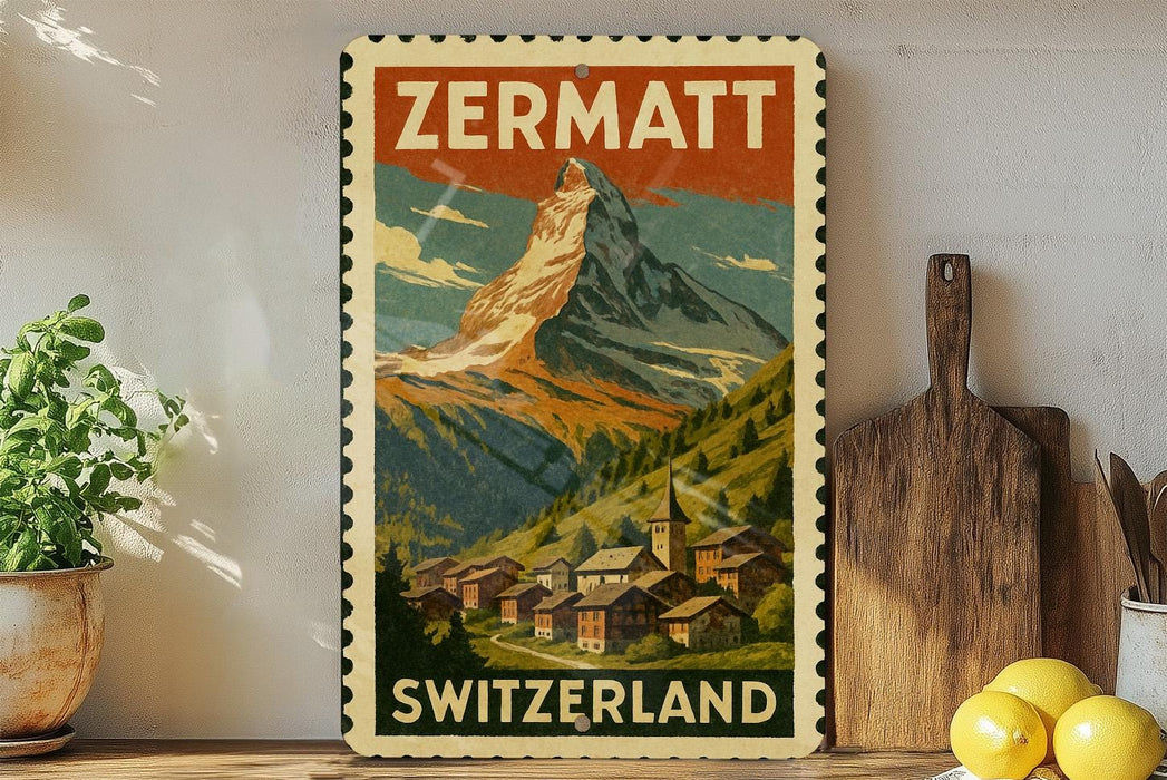 A vintage-style poster of the Matterhorn mountain in Switzerland, featuring a village in the foreground and the text "ZERMATT SWITZERLAND" at the bottom.