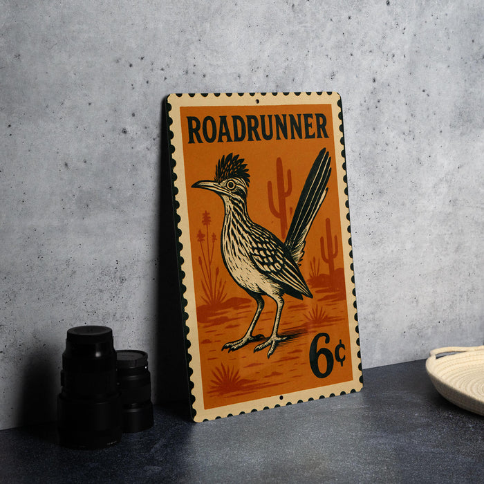 A metal sign featuring a Roadrunner bird, with the text "ROADRUNNER" and "6c" printed on it, is displayed on a table.