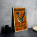 A metal sign featuring a Roadrunner bird, with the text "ROADRUNNER" and "6c" printed on it, is displayed on a table.