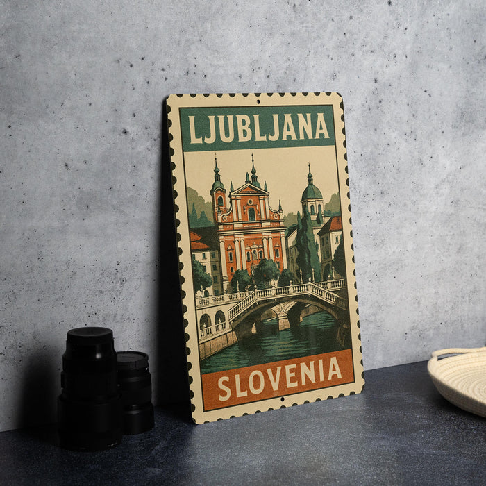 A vintage-style metal sign with the text "LJUBBLJANA SLOVENIA" and an illustration of a bridge and buildings, likely representing a travel destination.