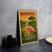 A metal sign with a pink flamingo and the text "PANTANAL BRASIL" is displayed on a gray wall.