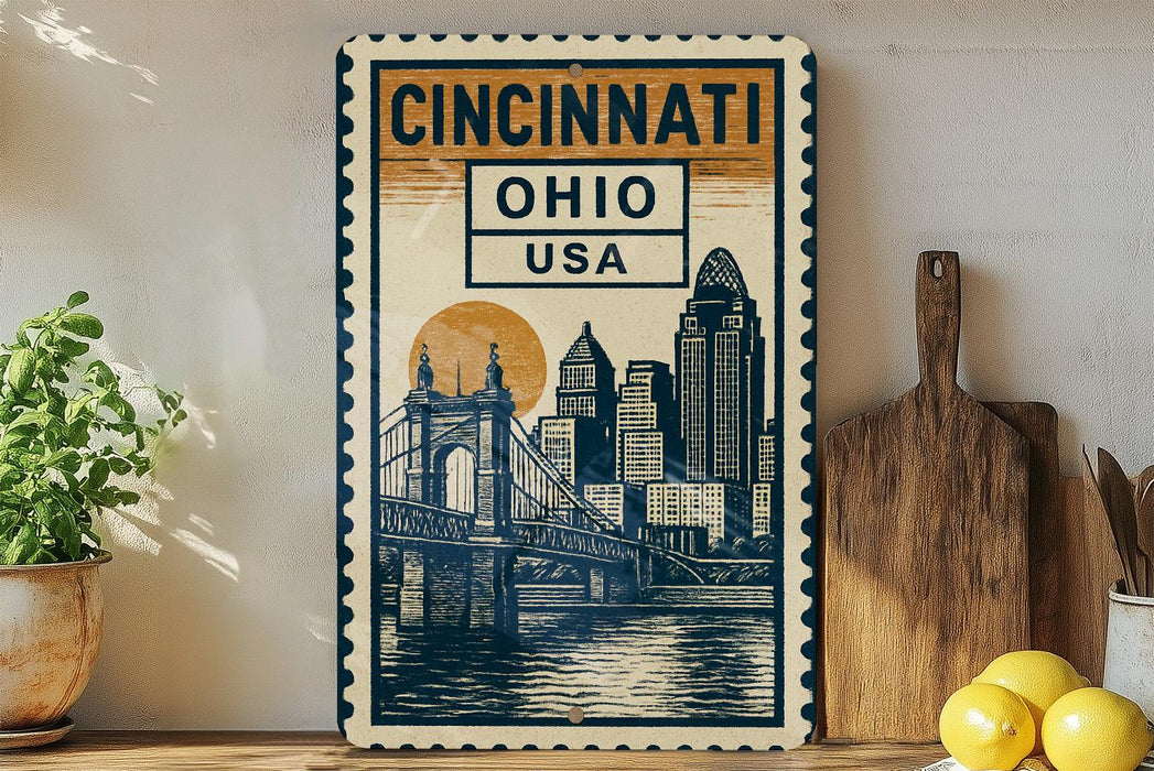 a decorative metal sign with a cityscape and a bridge, placed on a wooden surface next to a wooden cutting board and some lemons.