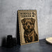 a metal sign with a dog illustration, placed on a table next to some black camera lenses.