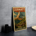 A vintage-style poster of the Matterhorn mountain in Switzerland, featuring a colorful illustration of the mountain and a small village in the foreground.