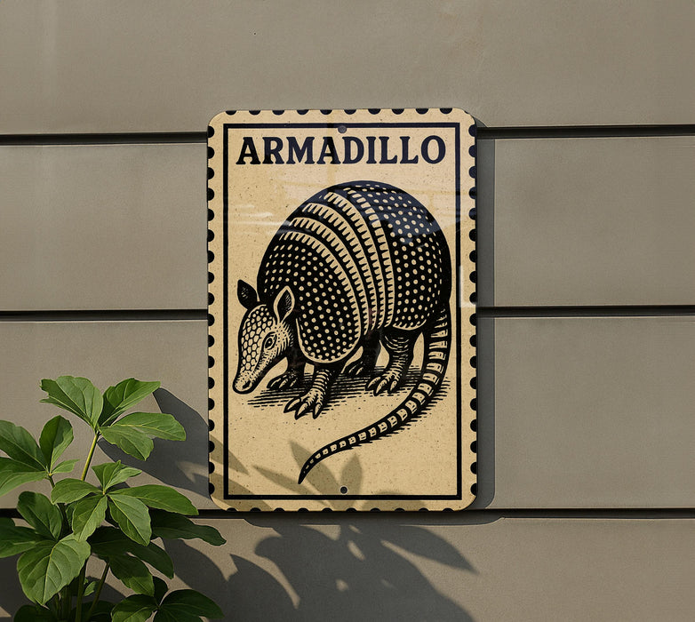 a sign with the word "ARMADillo" on it, mounted on a wall next to a plant.