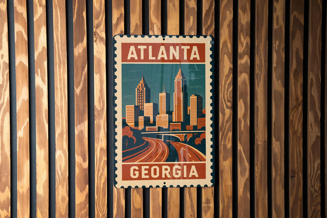 A vintage-style metal sign with the text "ATLANTA GEORGIA" displayed prominently, featuring an illustration of a city skyline.