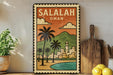 A framed vintage-style poster of Salalah, Oman, featuring a tropical landscape with palm trees, mountains, and a body of water.