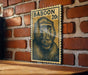 A wooden table with a wooden frame, and a framed image of a baboon on the wall.