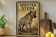 a framed illustration of a spotted hyena, with a wooden cutting board and a potted plant to the left.