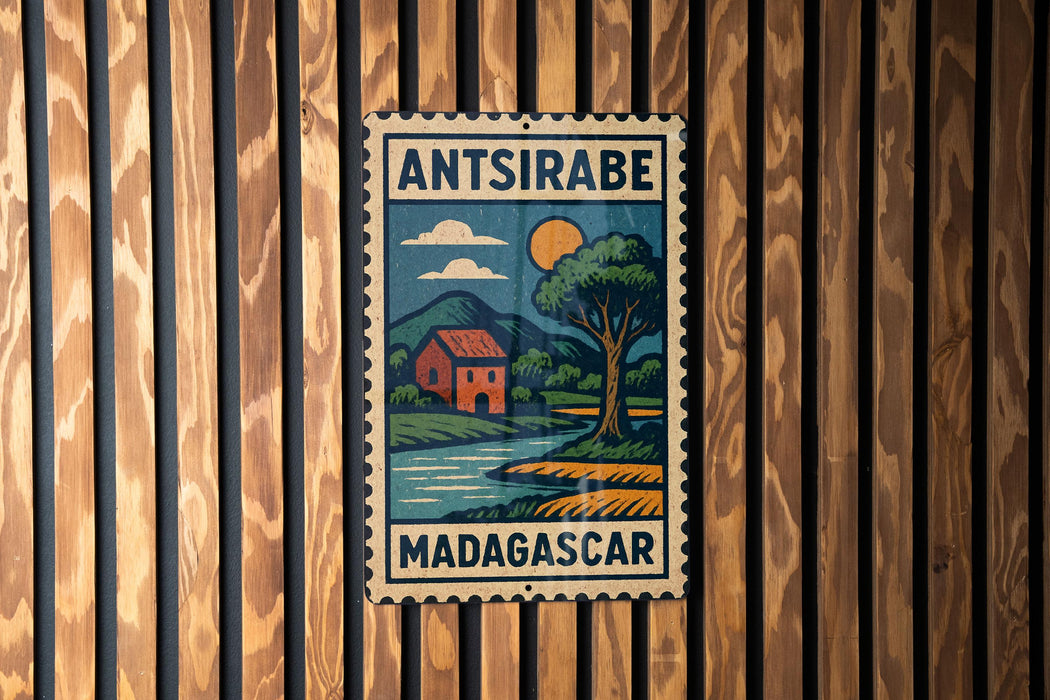a vintage-style stamp or sign with a tropical landscape, including a house, tree, and body of water, hanging on a wooden wall.