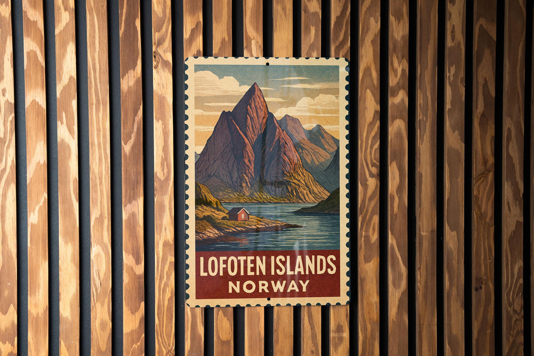 A vintage postage stamp featuring a mountain landscape with a small cabin, hanging on a wooden wall.