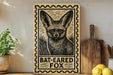 A wooden sign with a bat-eared fox illustration, accompanied by the text "BAT-EARED FOO" on a shelf.