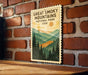 A framed poster of the Great Smoky Mountains National Park in the United States, featuring a scenic mountain landscape with pine trees and a sunset.