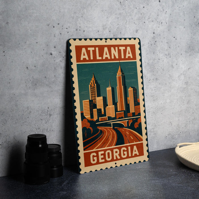 A metal sign with a stylized illustration of Atlanta, Georgia, featuring the city's skyline and highway.