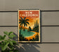 A vintage-style sign that reads "NEW CALEDONIA" is displayed on a wall, featuring a tropical beach scene with palm trees, a sunset, and a body of water.