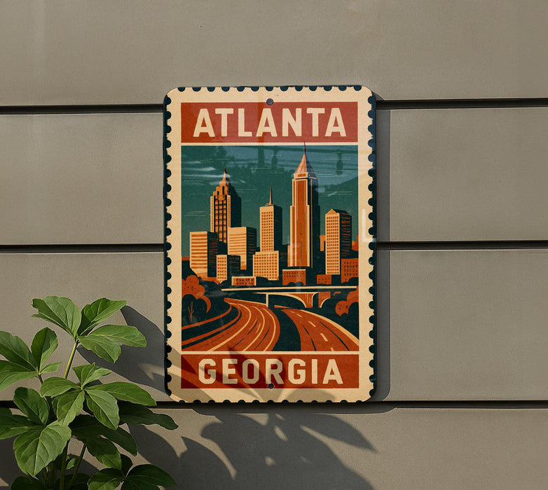 A vintage-style metal sign with the text "ATLANTA GEORGIA" and an illustration of a city skyline, mounted on a wall.