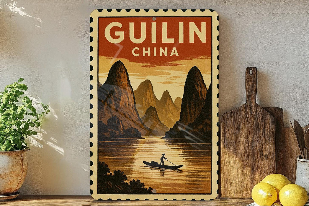 a framed vintage-style poster of Guilin, China, depicting a person in a boat on a river surrounded by mountains.