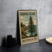 A vintage postage stamp from Norfolk Island, featuring a pine tree and a coastal landscape, is displayed on a table.