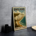 A metal sign with the text "ENGLAND" and "WHITE CLIFFS OF DOVER" is displayed on a table, depicting a scenic coastal landscape with cliffs overlooking the ocean.