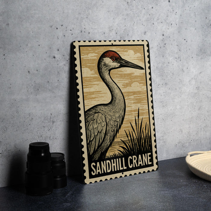 A metal sign featuring an illustration of a sandhill crane, with the text "Sandhill Crane" printed on it.