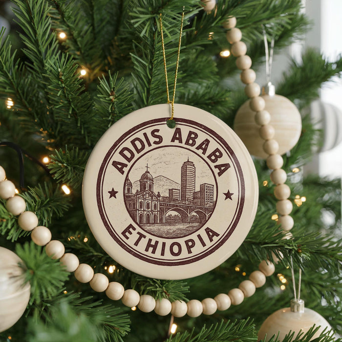A Christmas tree decorated with ornaments, including a circular ornament with the text "Addis Ababa Ethiopia" and a beaded ornament.